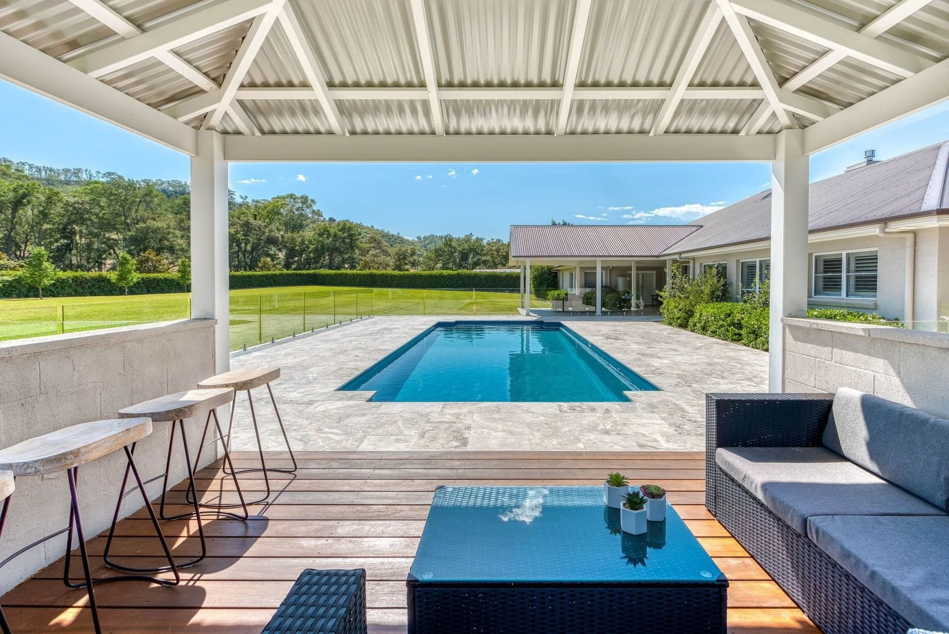 Swimming pool in a landscaped outdoor setting, illustrating pool design options
