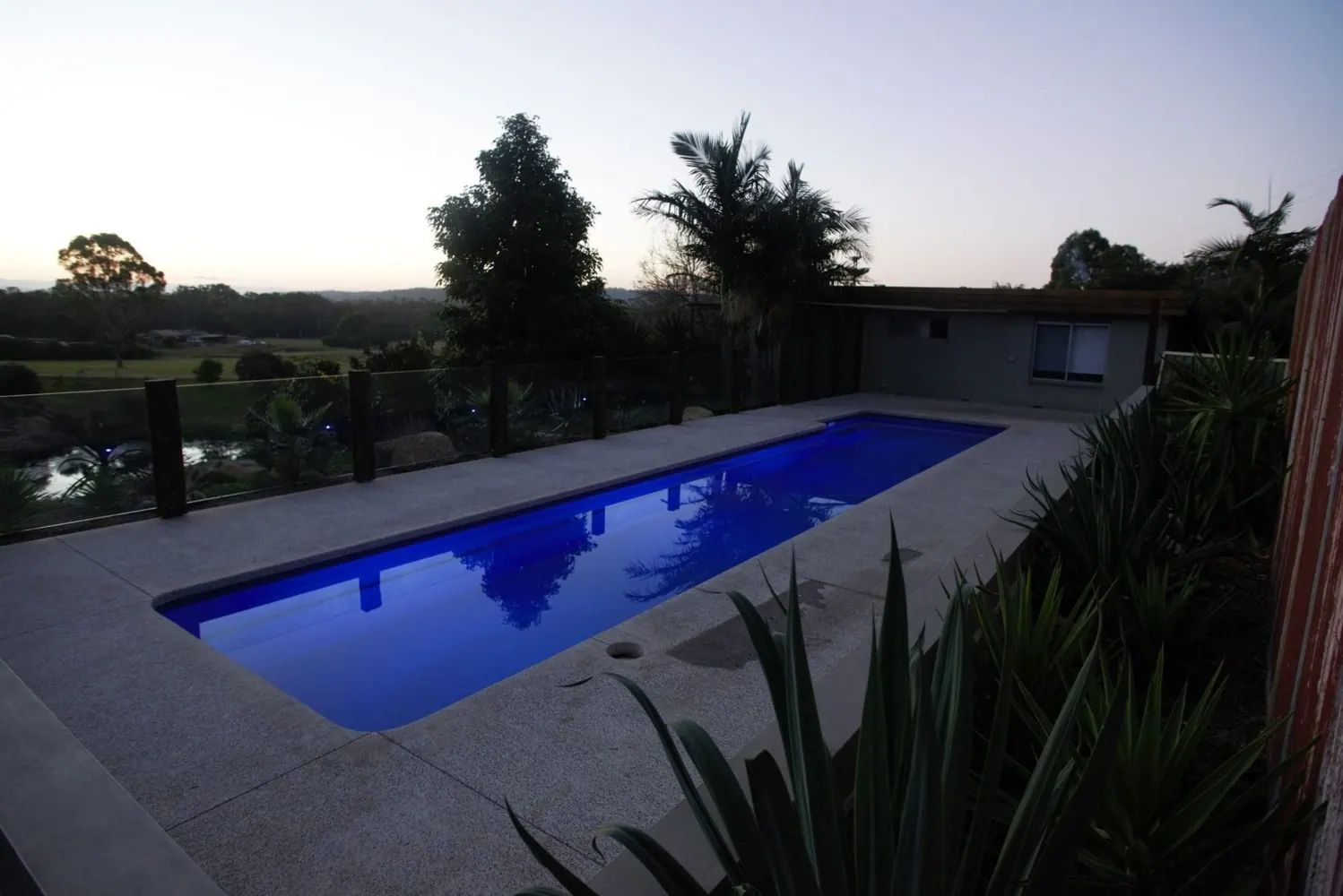 Long rectangular lap pool in an outdoor setting