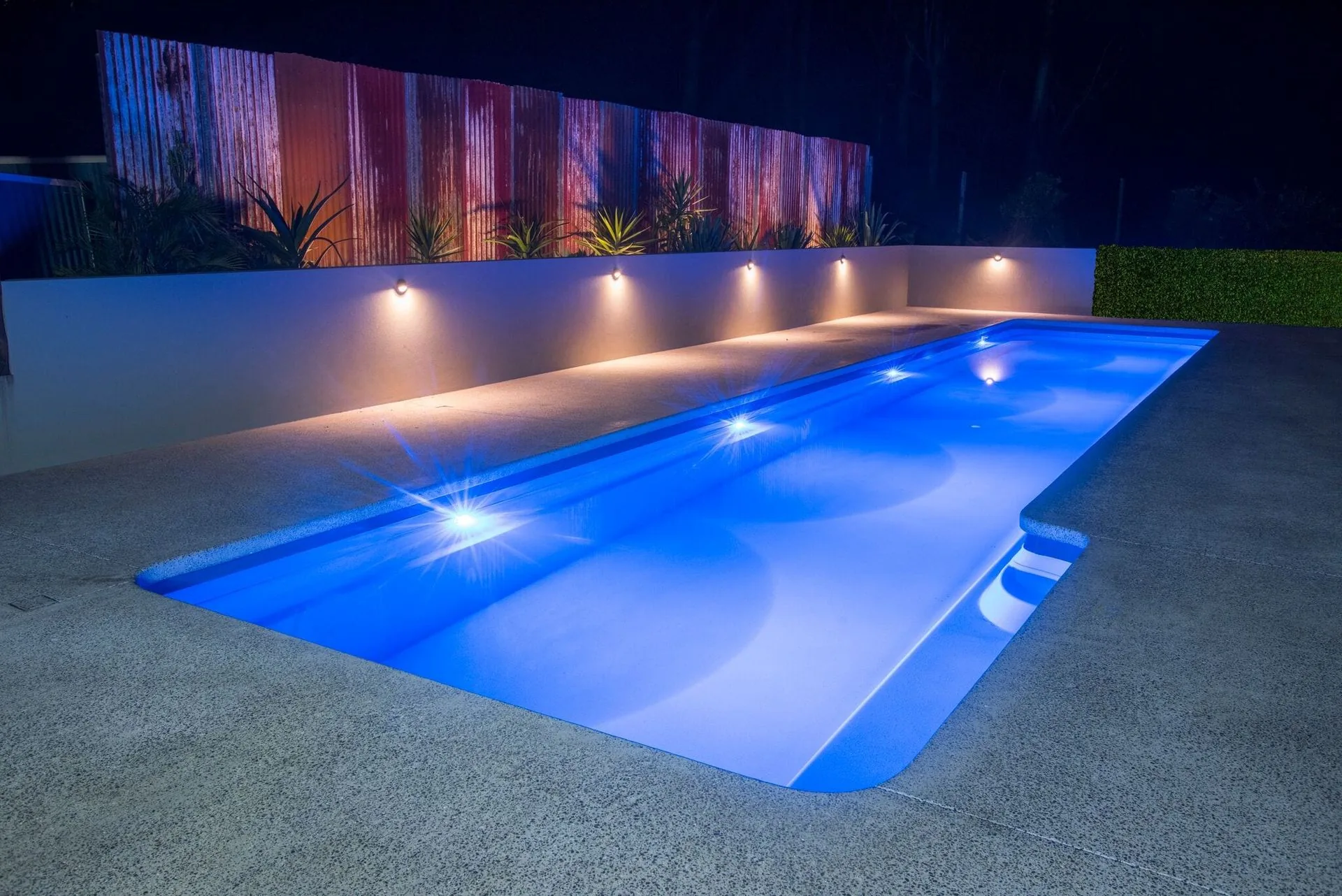 Pool with blue lighting and spa area