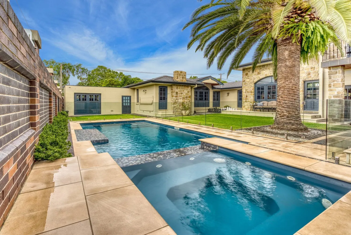 Swimming pool in a landscaped outdoor setting, illustrating pool design options